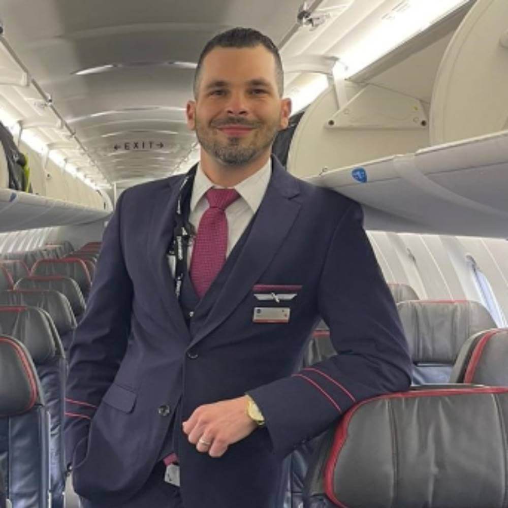 PSA airlines male flight attendant in uniform