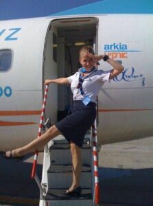 arkia female flight attendant happy
