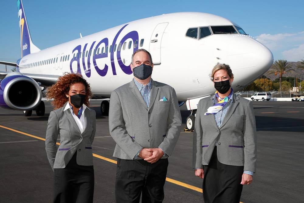 avelo airlines crew members in front of plane