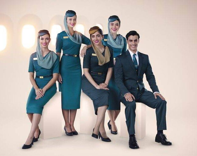 oman air male and female flight attendants in uniforms