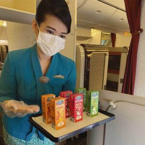 garuda indonesia flight attendant serving juice