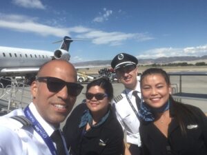go jet flight attendants with pilots and airplane background