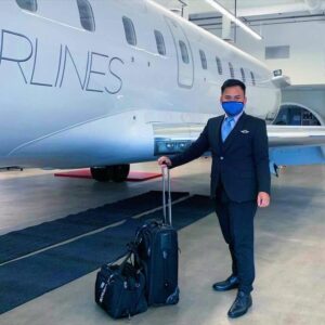 mesa airlines male flight attendant uniform with luggage