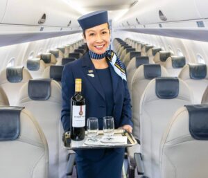 porter airline flight attendant serving wine