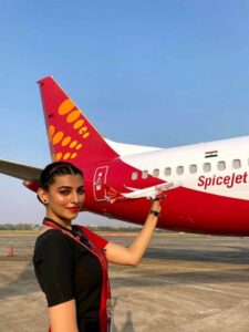 spice jet female cabin crew in front of plane