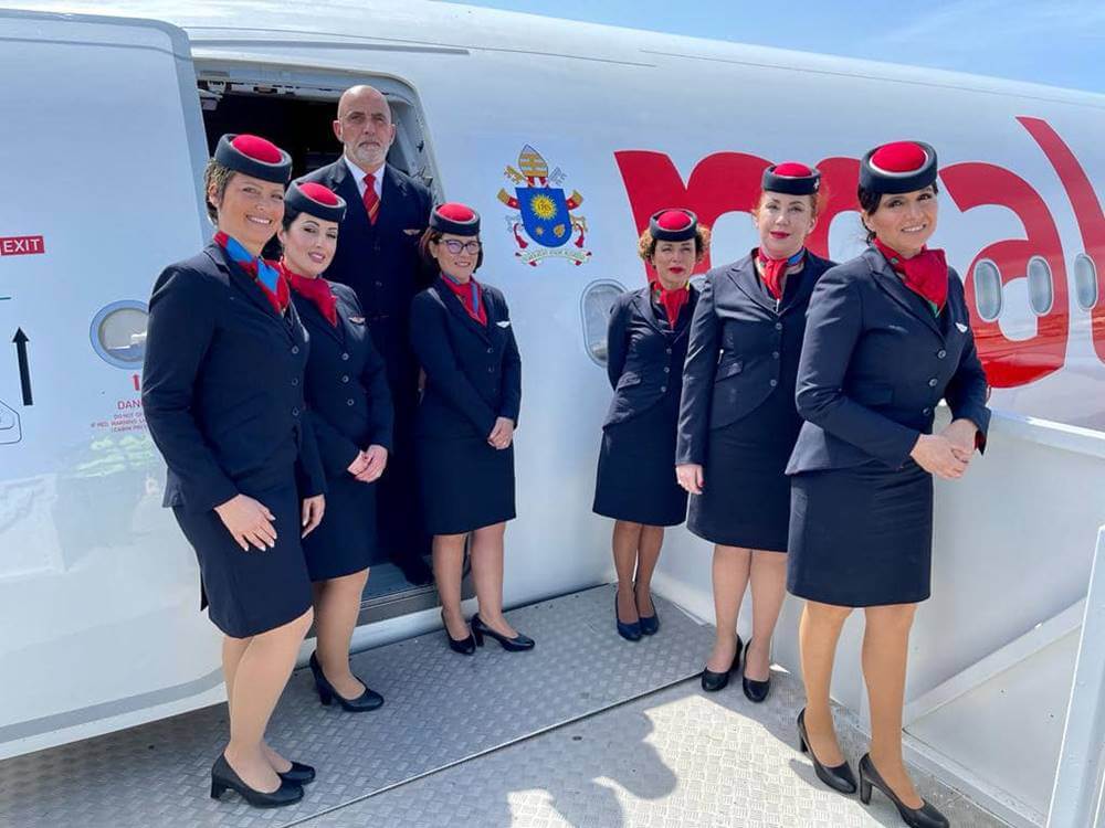 air malta flight attendants with airplane