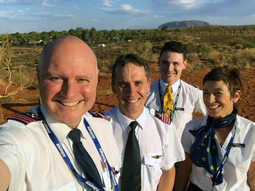 alliance airlines male and female flight attendant with pilots