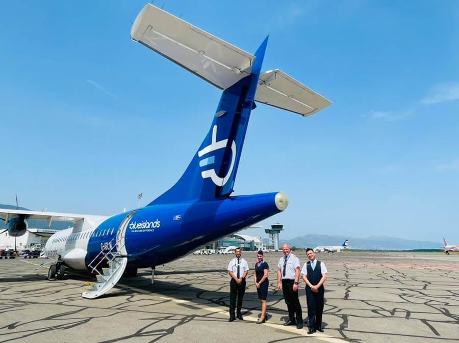 blue islands flight attendants with pilots and plane
