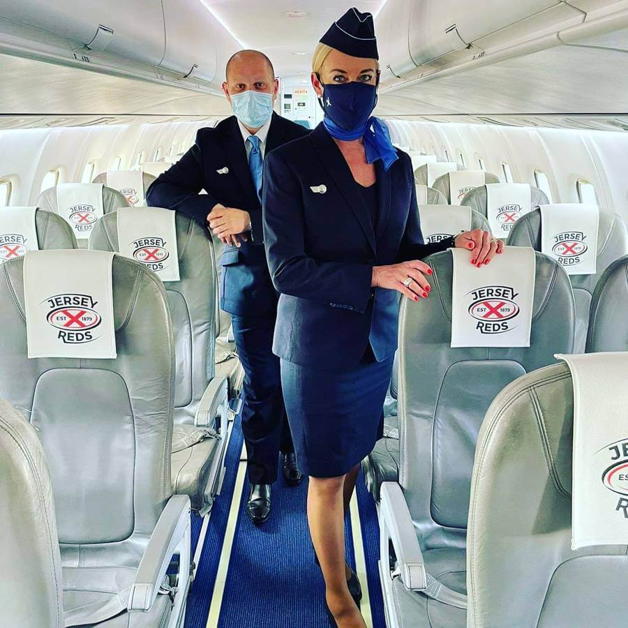 blue islands male and female flight attendants in plane