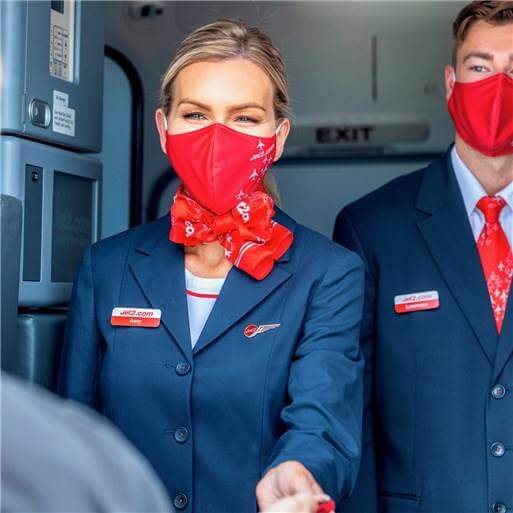 jet2 male and female flight attendants with masks