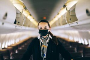 pal provincial airlines flight attendant with mask