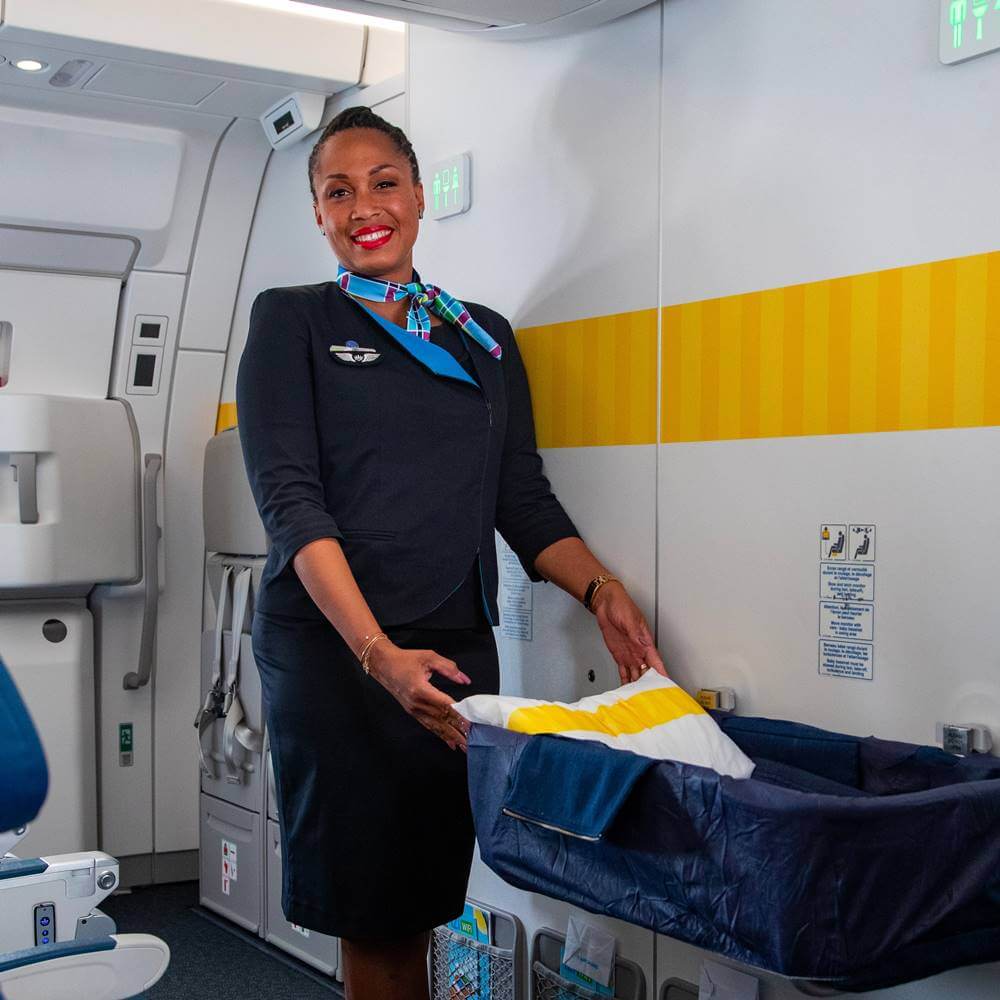 Air Caraibes female cabin crew bassinet