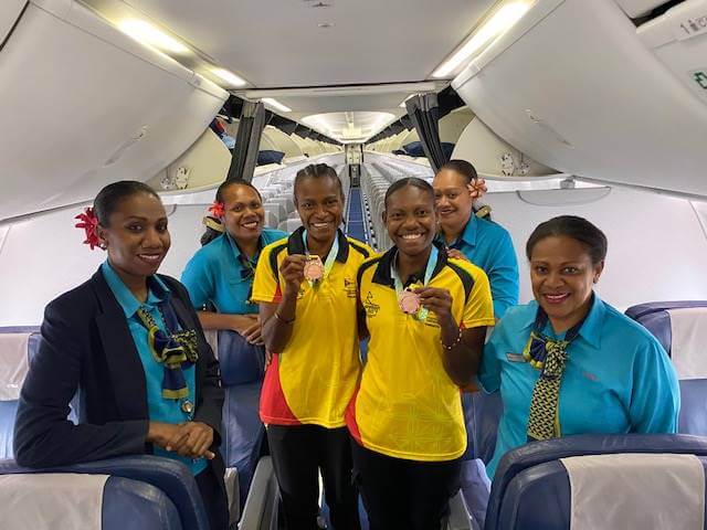 Air Vanuatu flight attendants with volleyball players