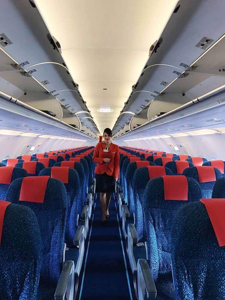 Aircalin female flight attendant cabin