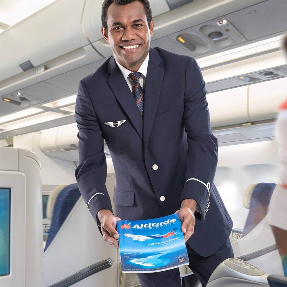 Aircalin male flight attendant happy