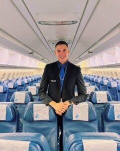 french bee male flight attendant smile