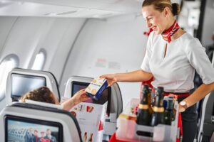 Air Belgium female cabin crew serving