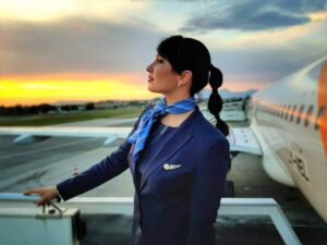 Avion Express female flight attendant sunset