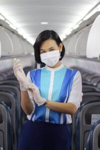 Bangkok Airways female flight attendant mask and gloves