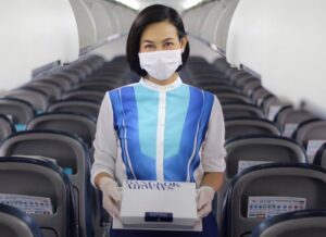 Bangkok Airways female flight attendant meal tray