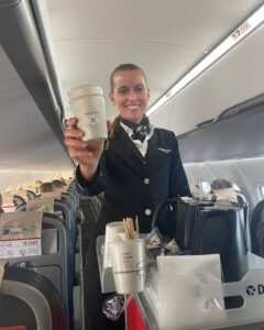 Danish Air Transport female flight attendant serving