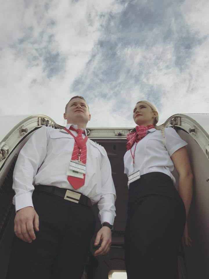 Fly CemAir male and female flight attendant boarding