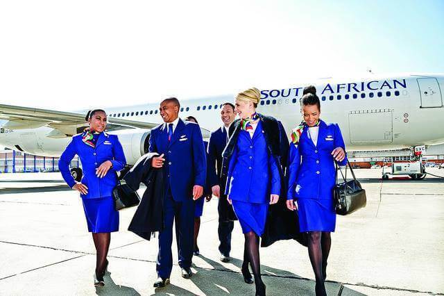 South African Airways male and female cabin crews walk