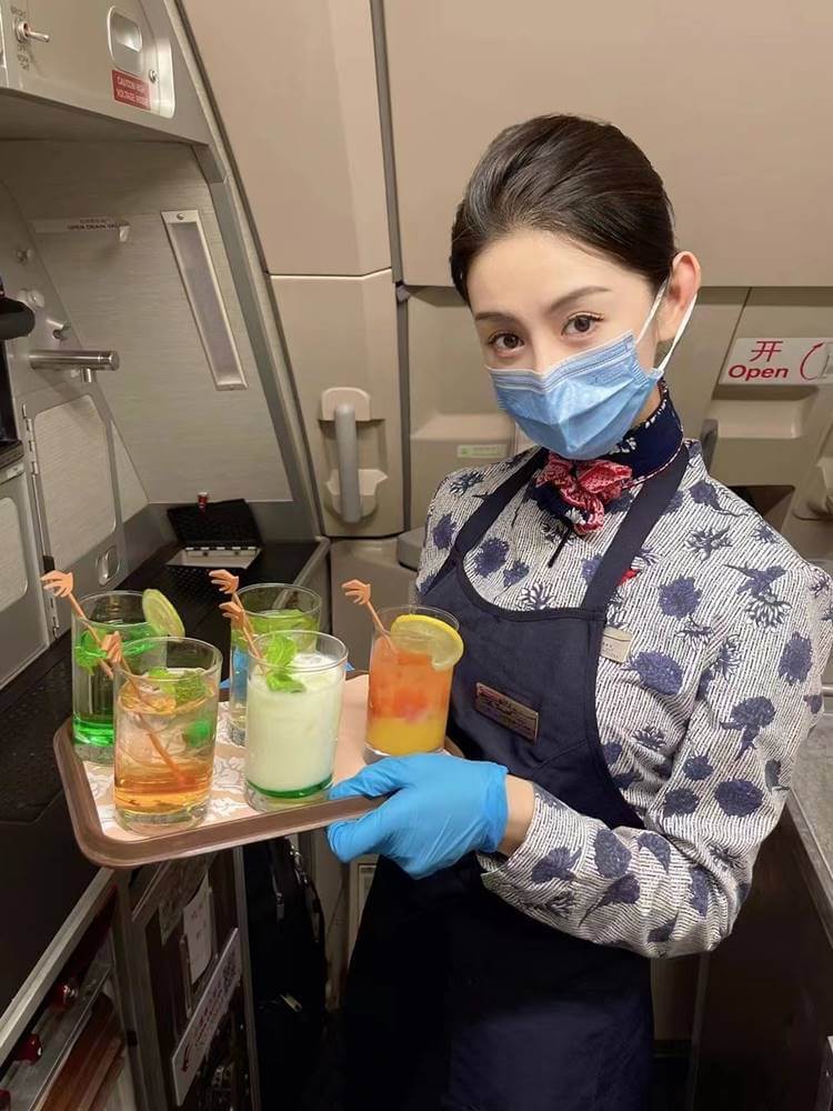 China Eastern Airlines flight attendant serving drinks