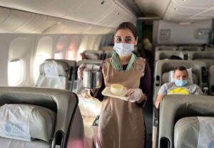 Pakistan International Airlines flight attendant hot beverage service