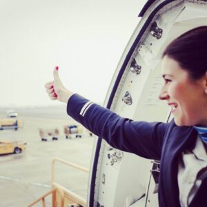 People's Airline female flight attendant thumbs up