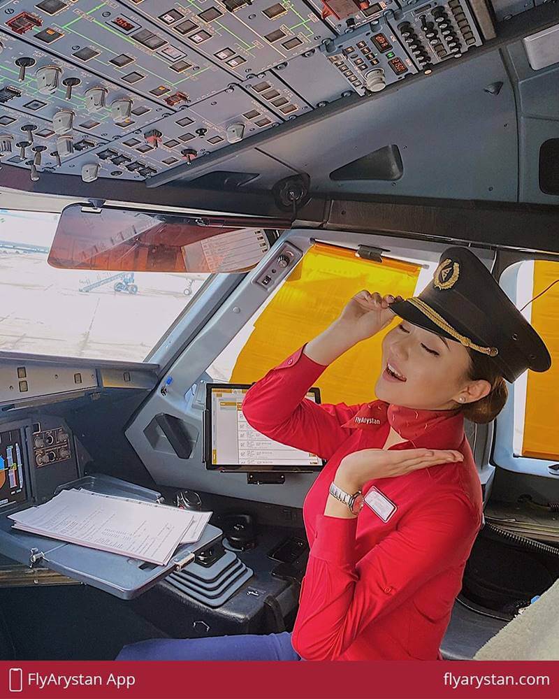 FlyArystan female flight attendant cockpit