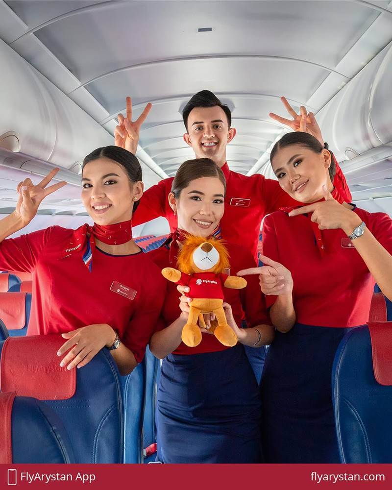 FlyArystan flight attendants with toy