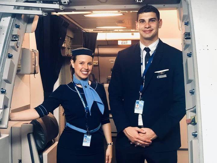 Aerolineas Estelar male and female flight attendant door