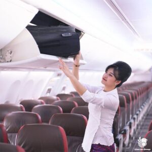Lion Air female flight attendant hat rack
