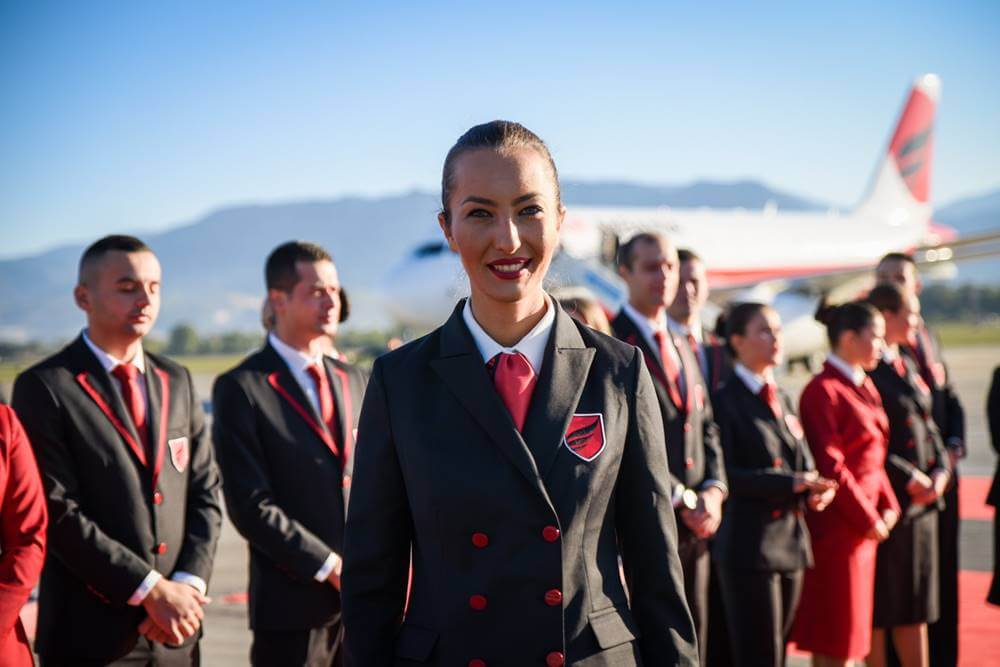 Air Albania female flight attendant happy