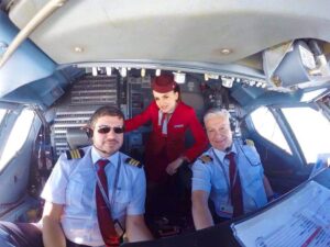 Albawings flight attendant and pilot cockpit