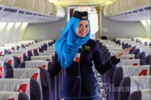 NAM Air female flight attendant boarding