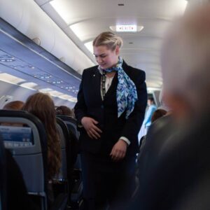 Niceair flight attendant securing cabin