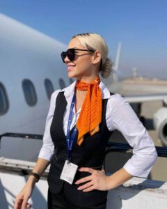 SmartLynx female flight attendant AC wings