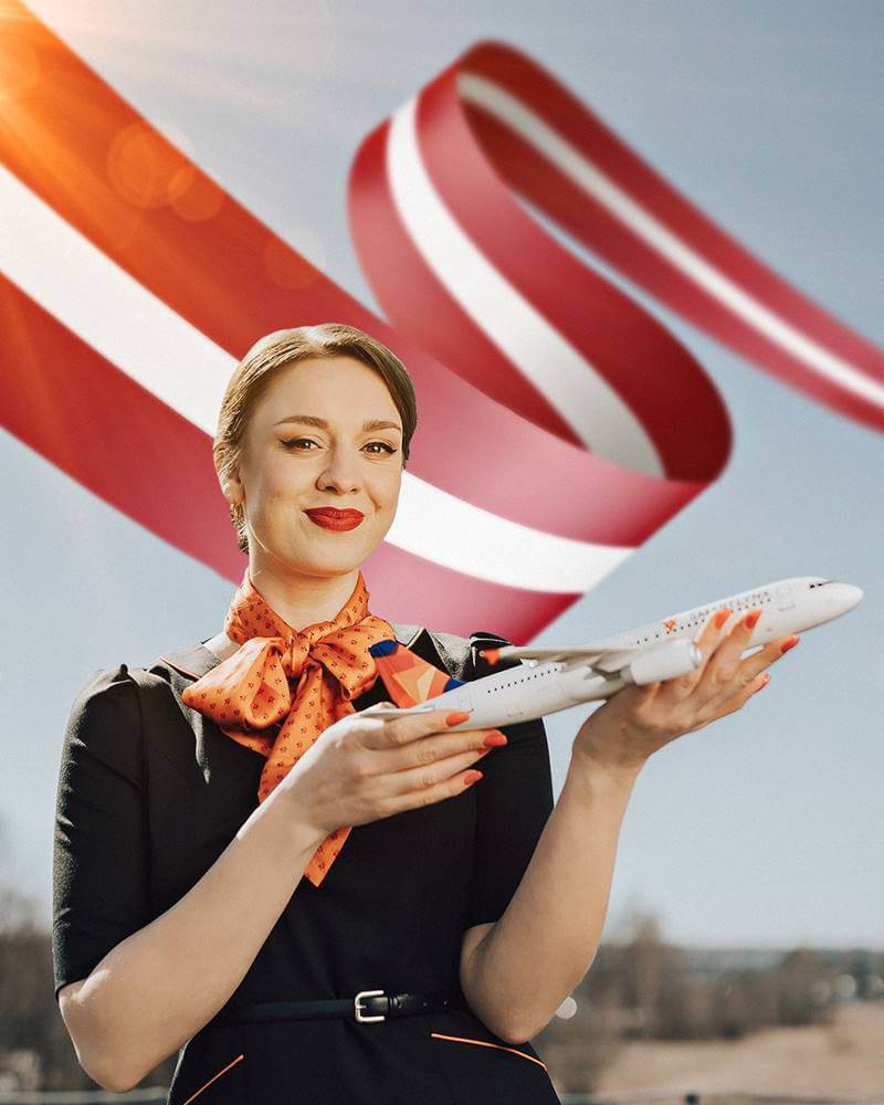 SmartLynx female flight attendant latvian flag
