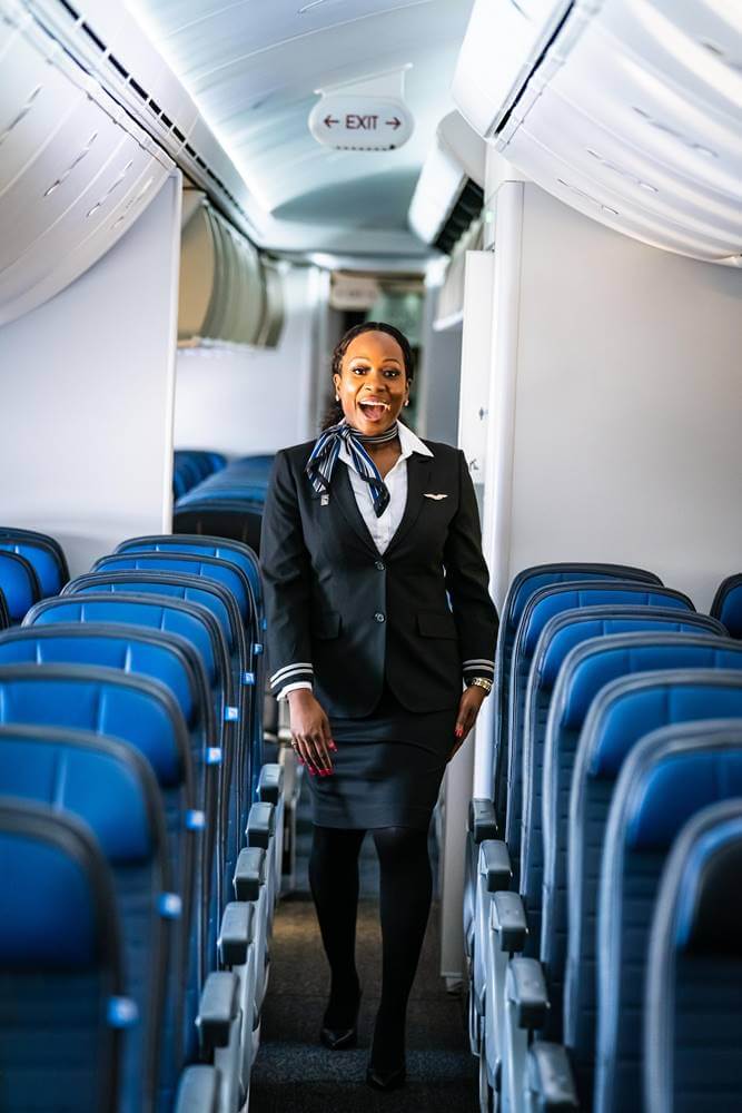 United Airlines female flight attendant aisle