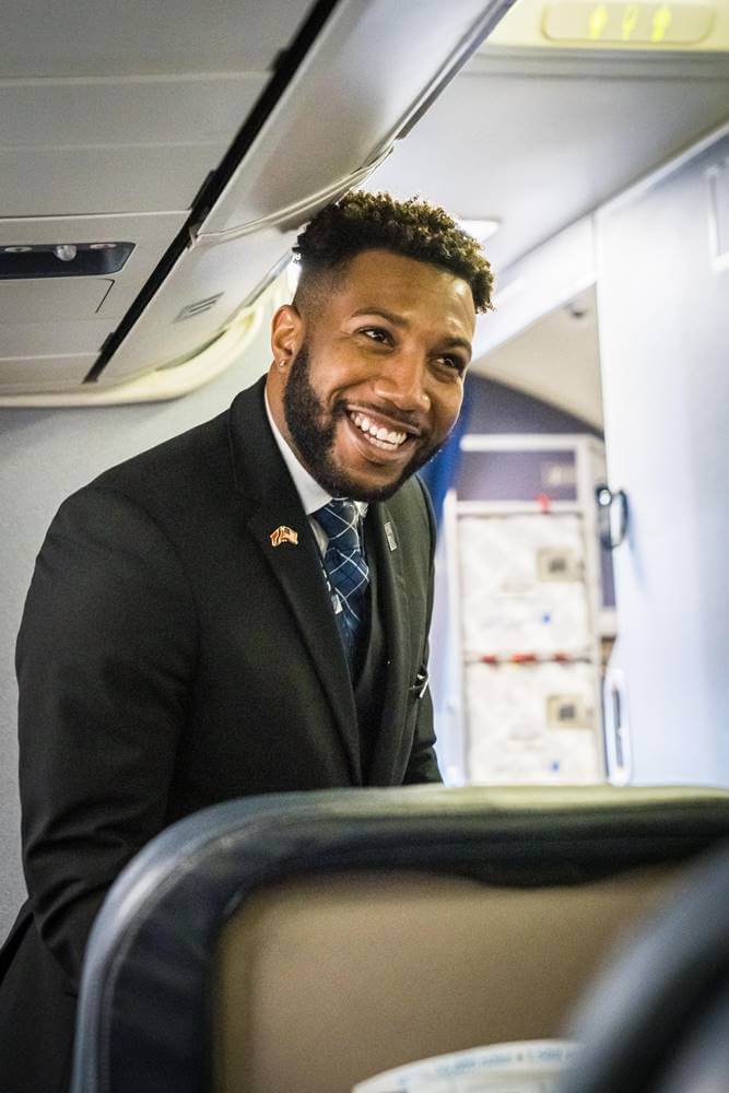 United Airlines male flight attendant happy